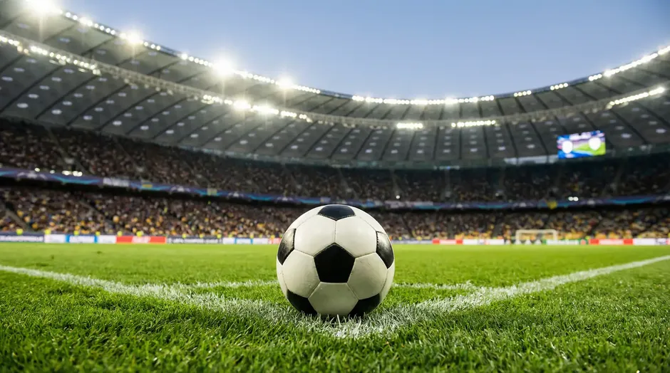Fodboldbane med bold foran et fyldt stadion som symbol på VM 2026-debutanternes store chance